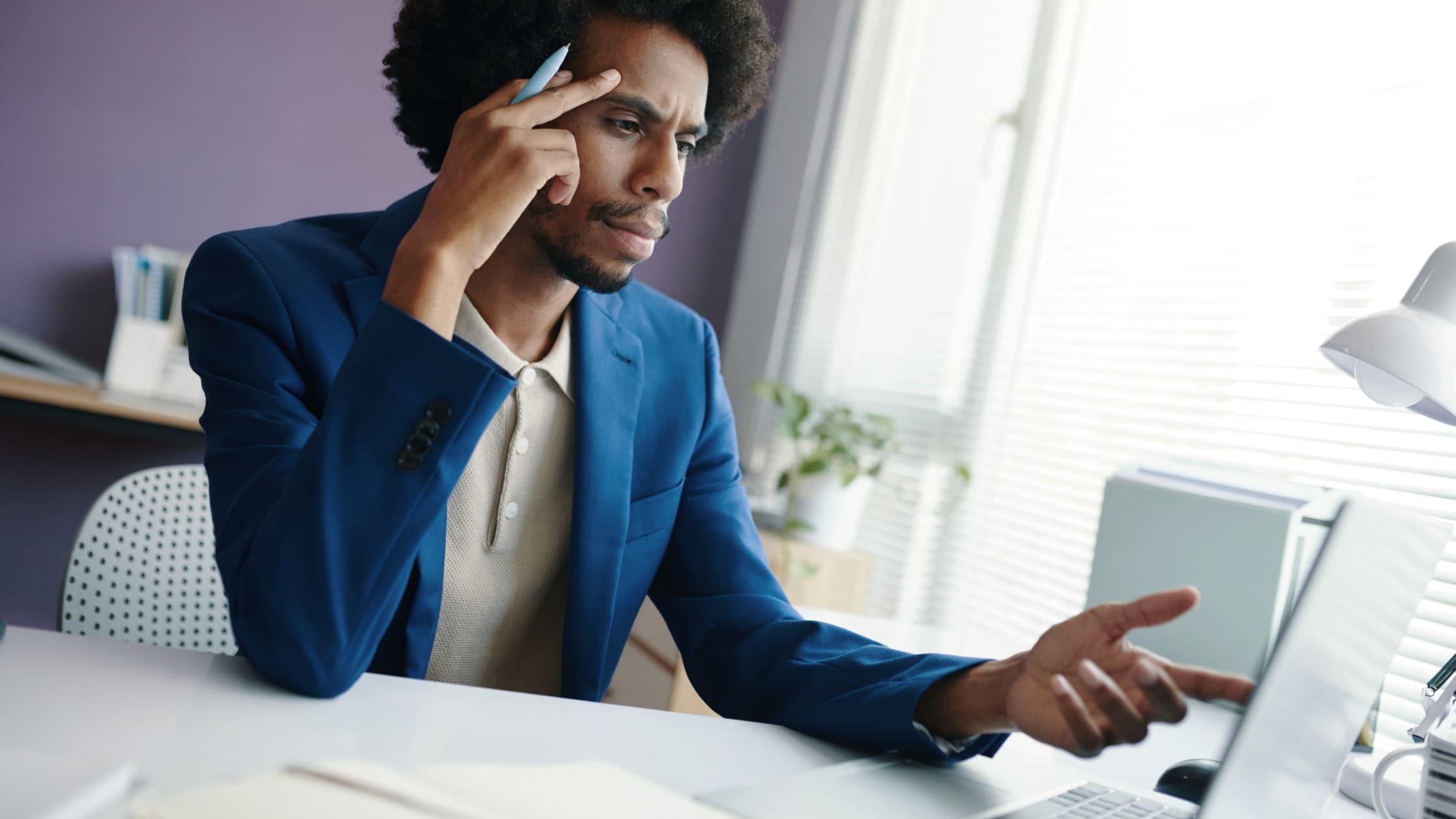Man at laptop, confused as to why he's not getting emails
